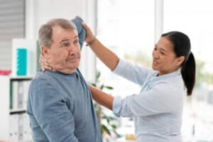 occupational therapist working with male patient
